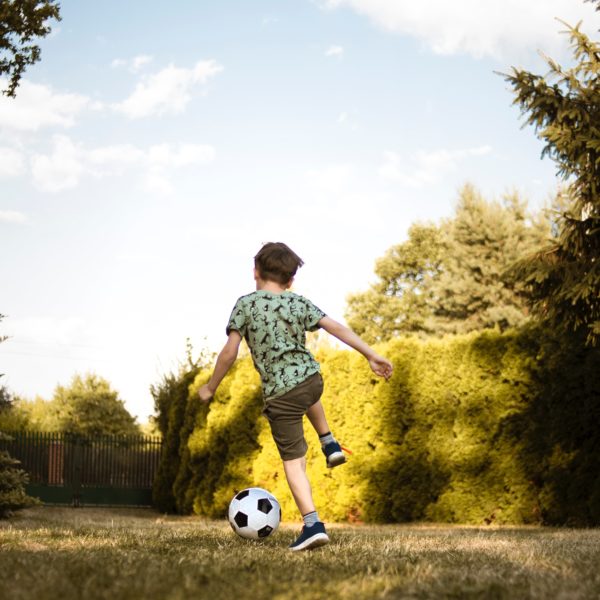 low-angle-photo-of-a-boy-playing-soccer-2682543